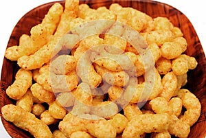 Puffed corn snacks with peanuts and cheese flavor