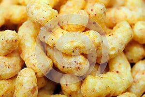Puffed corn snacks with peanuts and cheese flavor