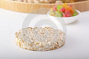 Puffed exploded wheat grains on candied fruit background