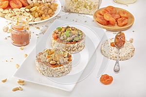 Puffed exploded wheat grains with peanuts and dried apricots, pistachios and candied fruits on a layer of apricot jam