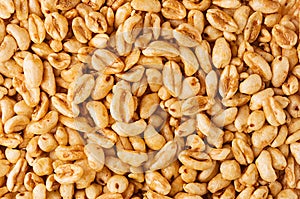 Puffed honey air rice wheat closeup background. Cereals texture.