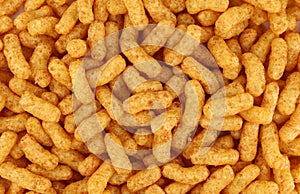 Puffed peanuts and corn snacks. Full frame.