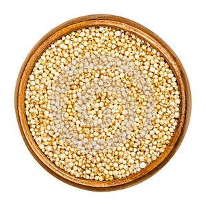Puffed quinoa in wooden bowl over white photo
