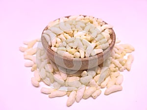 Puffed rice in a bowl over white background