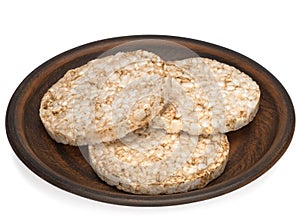 Puffed rice bread in a plate isolated on white background, diet crispy round rice waffles