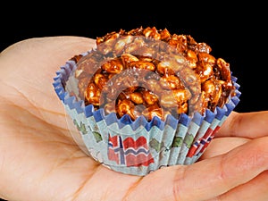 Puffed rice chocolate cake in paper cup with Norwegian flag