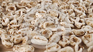 Puffed spelt wheat close up. Uncooked cereal flakes.