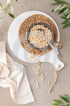 Puffed wheat in ceramic bowl. Cereal breakfast on kitchen table. Kitchen countertop. Cooking Healthy Food. Top view