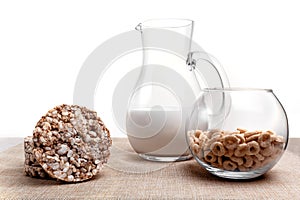 Puffed wheat, corn and milk jug rings on the tablecloth from a sacking
