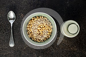 Puffed wheat covered with honey in bowl and milk