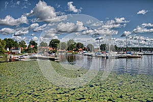 Puffy clouds, blue sky above a town on Malaren lake, Sweden