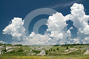 Puffy clouds in countryside photo