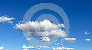 Puffy Clouds Floating in a Clear Blue Sky on a Sunny Day