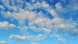 Puffy clouds moving in the blue sky during bright sunny summer day, timelapse