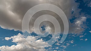 Puffy fluffy white clouds blue sky time lapse motion background.