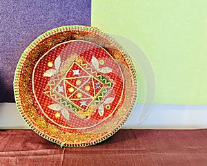 Puja plate.Decorated pooja thali made of papier mache and decorated with gold tone paper and lace