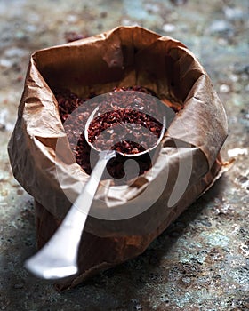 Pul biber with a spoon inside of a craft paper bag photo