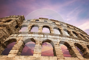 Pula amfitheater with pink evening dramatic sky