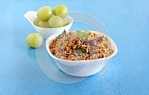 Puliyogare South Indian Vegetarian Rice Dish in a Bowl and a Main Ingredient Indian Gooseberry