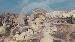 Pull-back, 4k aerial drone footage of the remains of a carved home in Cappadocia of central Turkey.
