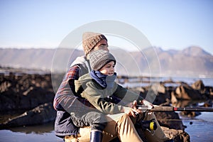 Pull dad...a loving father and son fishing by the sea.