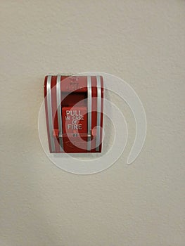 Pull fire alarm handle on wall red