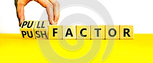 Pull or push factor symbol. Concept word Pull factor and Push factor on wooden cubes. Beautiful yellow table white background.