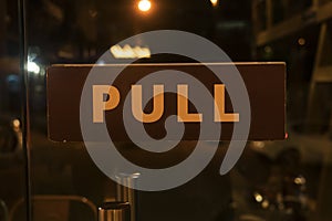Pull sign board on a glass door
