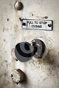 Pull to stop engine sign above a pull control.