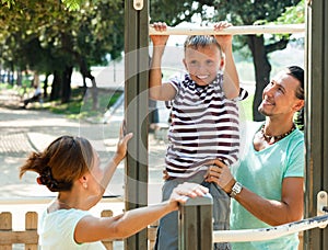 On pull-up bar at playground