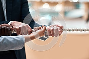 Pull your goals closer towards you. Closeup shot of businesspeople tugging on a rope in an office.