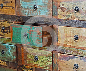 Pulled drawer on old wooden colorful dresser