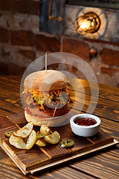 Pulled pork BBQ burger with tomatoes and jalapeno selected focus