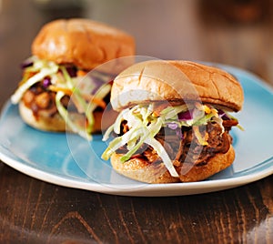 Pulled pork with bbq sauce on a blue plate photo