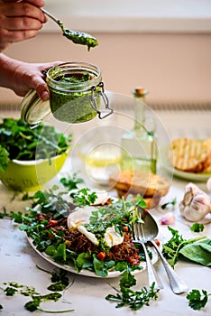 Pulled pork and vegy hash arugula chmichurri. selective focus
