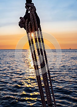 Pulley silhouette on a sailboat at sunset