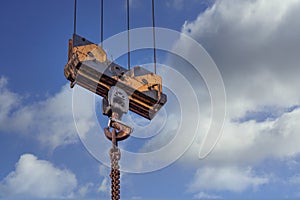 Pulley of a tower crane with fastening hook and chain