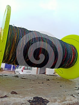 A pulley wrapped with strings used to fly kites.