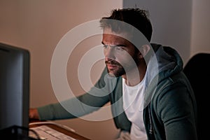 Pulling an all-nighter. a young designer working late in the office. photo