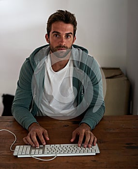 Pulling an all-nighter. a young designer working late in the office. photo