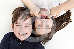 Pulling cheeky faces