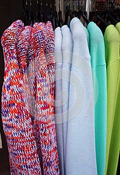 Pullovers on hangers.