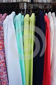Pullovers on hangers.