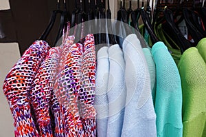 Pullovers on hangers.