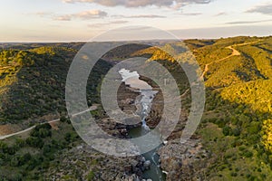 Pulo do Lobo waterfall drone aerial view with river guadiana and beautiful green valley landscape at sunset in Mertola Alentejo, photo