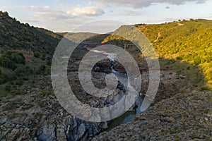 Pulo do Lobo waterfall drone aerial view with river guadiana and beautiful green valley landscape at sunset in Mertola Alentejo, photo