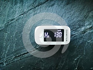 A pulse oximeter on blue background