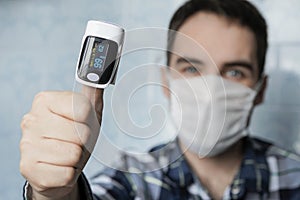 Pulse oximeter on finger is a good way to test blood oxygen level in case of virus infection of lungs. High saturation index,