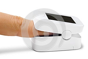 Pulse oximeter on finger on white background