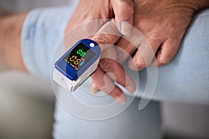 Pulse oximeter, healthcare and woman taking her heart rate in a retirement home during consultation. Medical, treatment